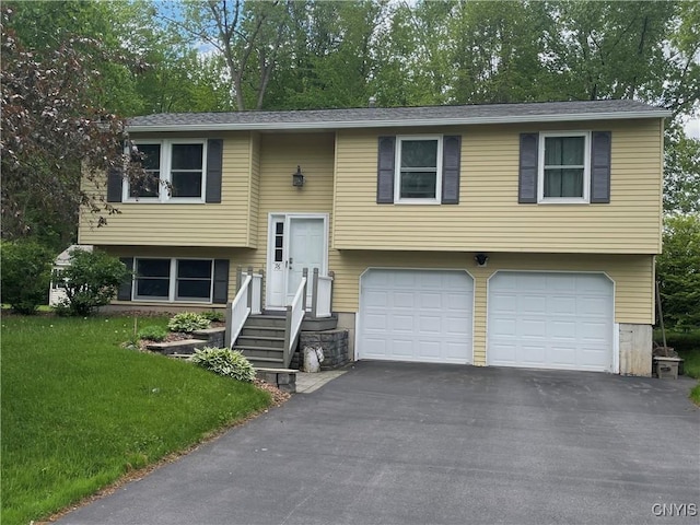 76 Windebank Ln, Manlius, NY 13116 - split foyer home with an attached garage, driveway, a front yard, and view of wooded area