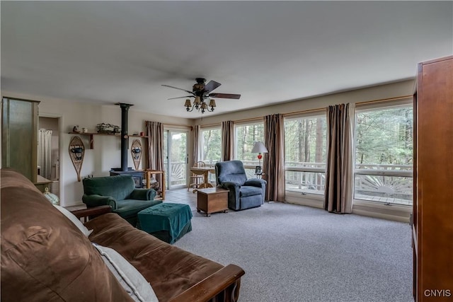 7678 N Shore Rd, Watson, NY 13343 - carpeted living room with a wood stove and a ceiling fan
