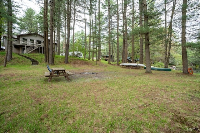 7678 N Shore Rd, Watson, NY 13343 - view of green lawn with a wooden deck and stairway