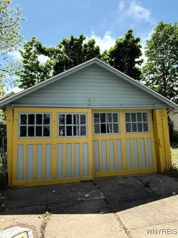 view of property exterior featuring an outbuilding and a garage