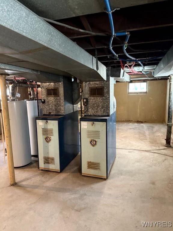basement featuring gas water heater and heating unit