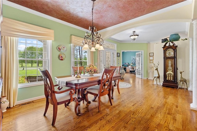 1619 Five Mile Ln Rd, Penfield, NY 14526 - dining area with arched walkways, light wood-style flooring, a chandelier, baseboards, and crown molding