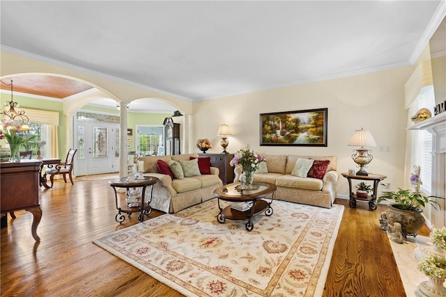 1619 Five Mile Ln Rd, Penfield, NY 14526 - living area with arched walkways, ornate columns, wood finished floors, crown molding, and baseboards