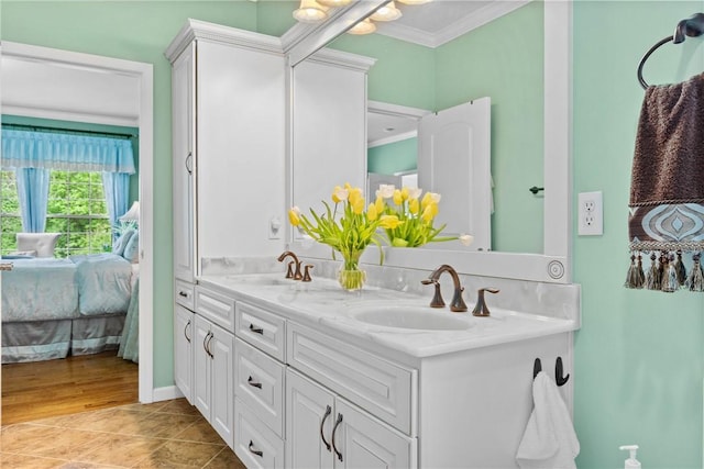 1619 Five Mile Ln Rd, Penfield, NY 14526 - ensuite bathroom with ornamental molding, double vanity, and tile patterned flooring