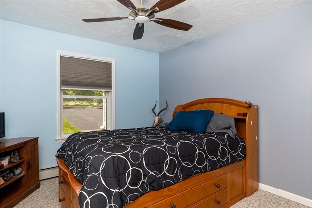2208 Davis Rd, Corning, NY 14830 - bedroom with a baseboard radiator, baseboards, a textured ceiling, light carpet, and a ceiling fan