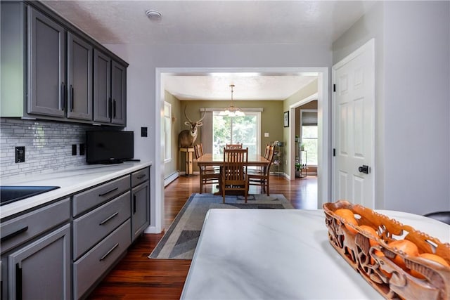 2208 Davis Rd, Corning, NY 14830 - kitchen featuring a baseboard radiator, light countertops, dark wood-style floors, gray cabinetry, and backsplash