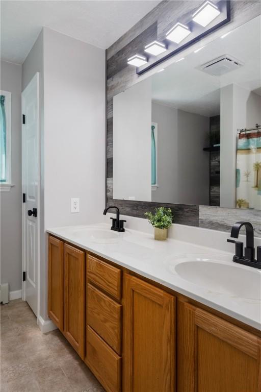 2208 Davis Rd, Corning, NY 14830 - bathroom with double vanity and baseboards