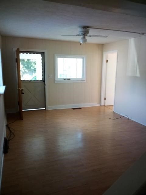404 Perry St, Horseheads, NY 14845 - unfurnished living room with wood finished floors, ceiling fan, plenty of natural light, and baseboards