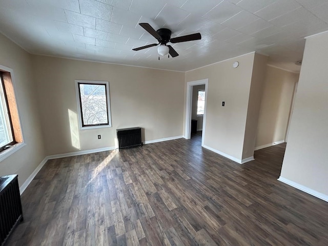 232 Birchwood Ave, Horseheads, NY 14903 - unfurnished room featuring ceiling fan, dark wood finished floors, baseboards, and radiator heating unit
