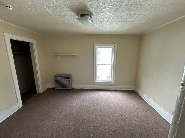 237 Scottwood Ave, Horseheads, NY 14903 - unfurnished bedroom with radiator, carpet flooring, ornamental molding, and baseboards