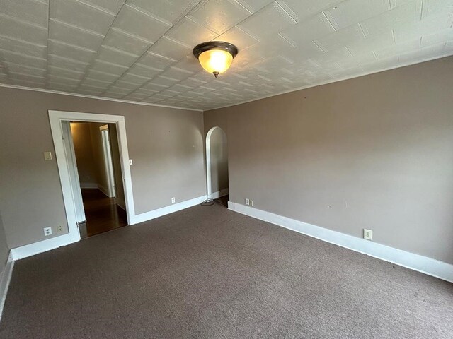 237 Scottwood Ave, Horseheads, NY 14903 - unfurnished room featuring arched walkways, dark carpet, and baseboards