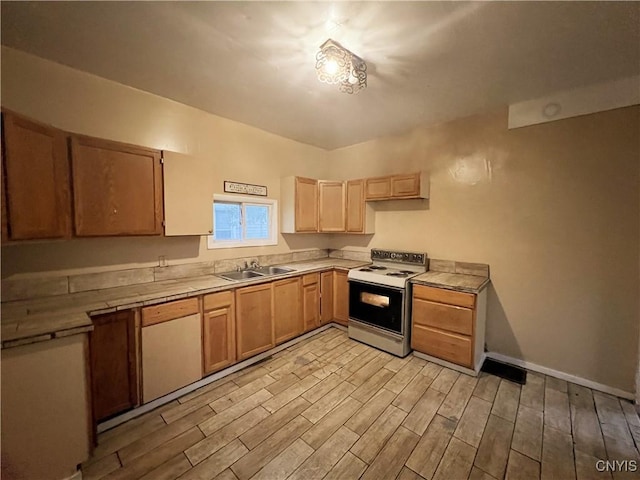 308 Rowland St, Syracuse, NY 13204 - kitchen with white electric range, a sink, light wood-type flooring, and tile counters
