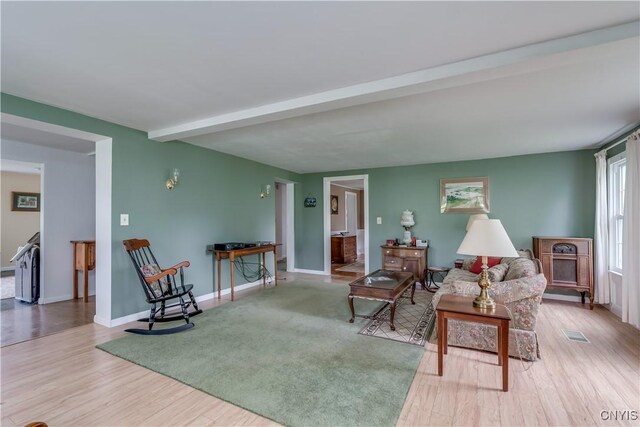 485 E Joseph St, Cape Vincent, NY 13618 - living room with wood finished floors, beamed ceiling, and baseboards
