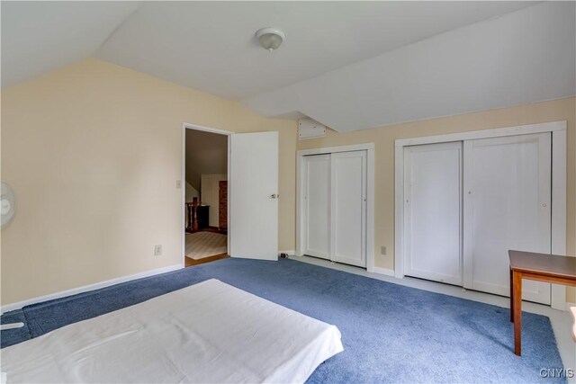 485 E Joseph St, Cape Vincent, NY 13618 - unfurnished bedroom with two closets, lofted ceiling, carpet floors, and baseboards