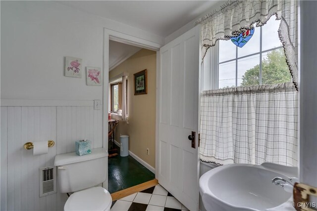 485 E Joseph St, Cape Vincent, NY 13618 - bathroom with toilet, healthy amount of natural light, a sink, and wainscoting