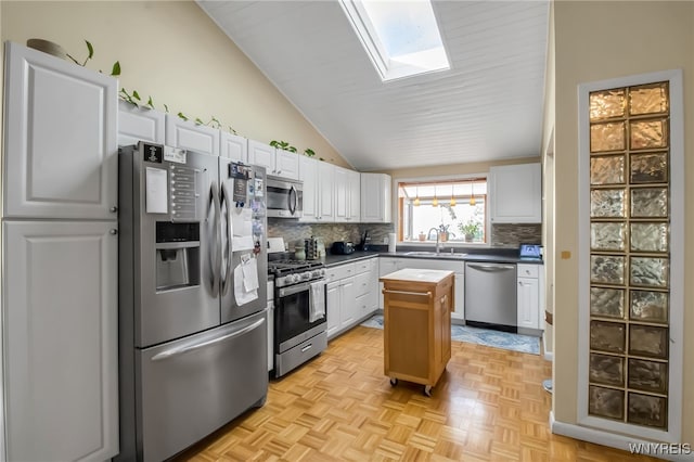 47 Acacia Dr, Amherst, NY 14228 - kitchen with appliances with stainless steel finishes, a skylight, vaulted ceiling, decorative backsplash, and a sink
