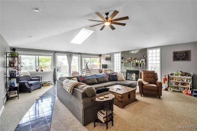 47 Acacia Dr, Amherst, NY 14228 - living room featuring lofted ceiling, healthy amount of natural light, a skylight, a ceiling fan, and tile patterned floors