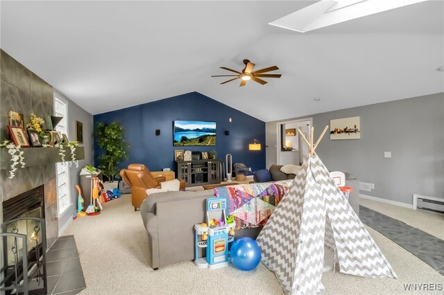 47 Acacia Dr, Amherst, NY 14228 - living room with a tile fireplace, carpet, lofted ceiling, a ceiling fan, and a skylight