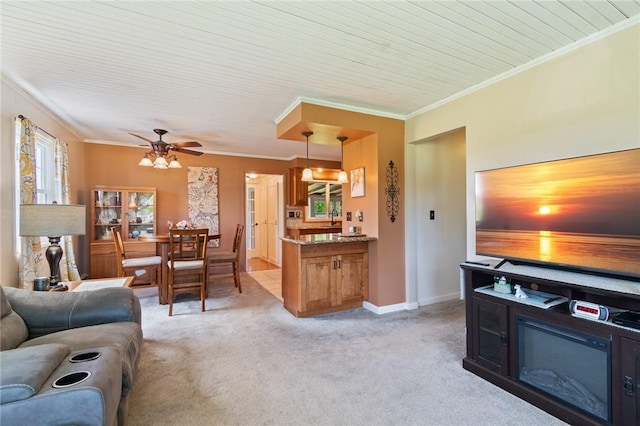 2600 Lake Rd, Ontario, NY 14519 - living room with light colored carpet, ornamental molding, ceiling fan, and baseboards