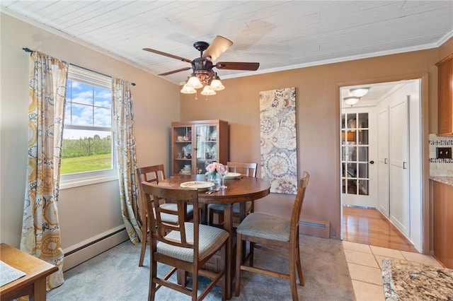 2600 Lake Rd, Ontario, NY 14519 - dining space with baseboard heating, light tile patterned floors, a ceiling fan, and ornamental molding