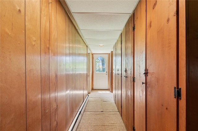2600 Lake Rd, Ontario, NY 14519 - corridor with a baseboard heating unit, light carpet, and wood walls
