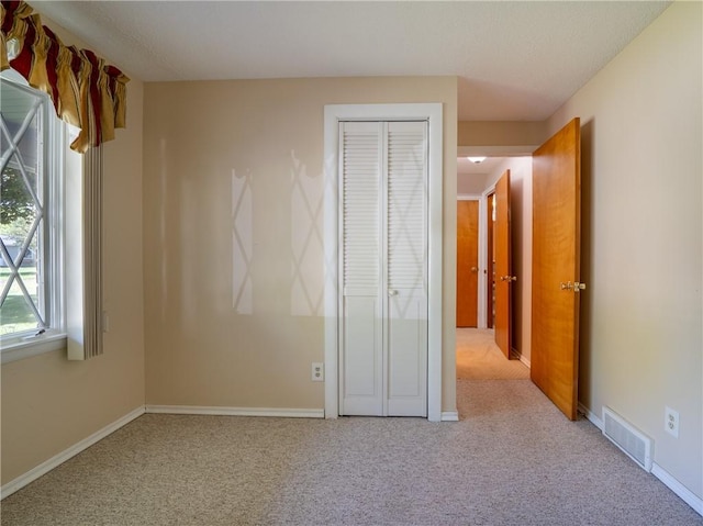 28 Kernwood Dr, Gates, NY 14624 - unfurnished bedroom with carpet, a closet, and baseboards