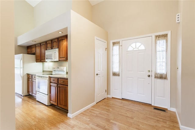 15 Stag Creek Trl, Clarkson, NY 14420 - entrance foyer featuring a towering ceiling, light wood finished floors, and baseboards