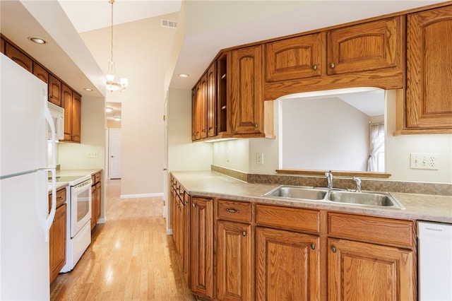15 Stag Creek Trl, Clarkson, NY 14420 - kitchen featuring white appliances, a sink, vaulted ceiling, brown cabinets, and light wood-type flooring