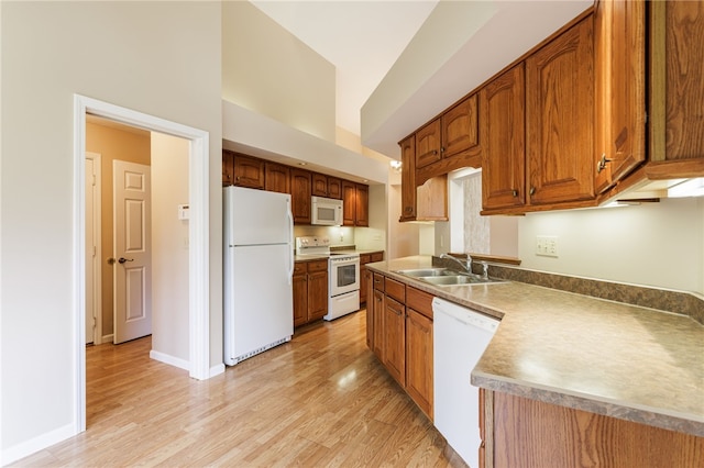 15 Stag Creek Trl, Clarkson, NY 14420 - kitchen with white appliances, a sink, light wood-style flooring, brown cabinets, and baseboards
