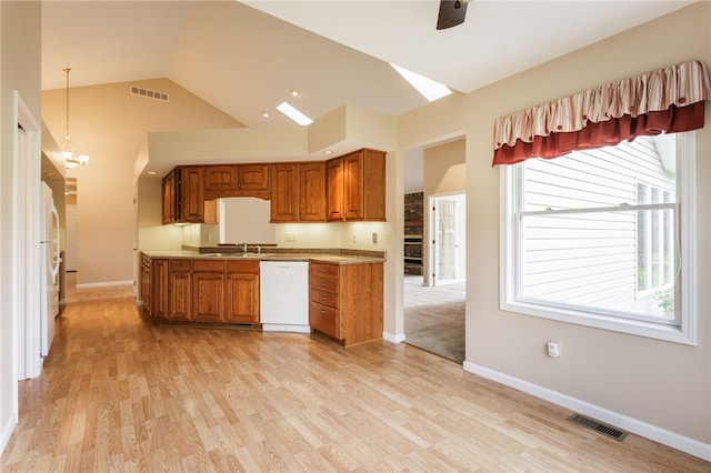 15 Stag Creek Trl, Clarkson, NY 14420 - kitchen featuring white appliances, brown cabinets, light wood-type flooring, high vaulted ceiling, and baseboards
