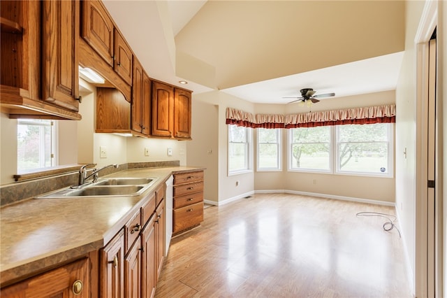 15 Stag Creek Trl, Clarkson, NY 14420 - kitchen with a sink, brown cabinets, plenty of natural light, and baseboards