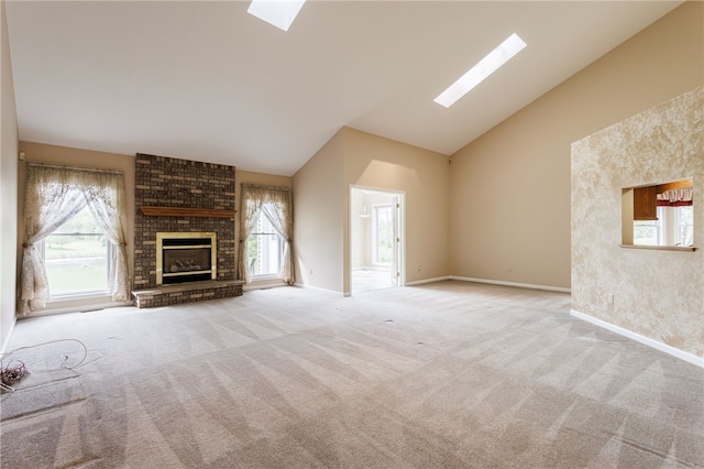 15 Stag Creek Trl, Clarkson, NY 14420 - unfurnished living room featuring a skylight, high vaulted ceiling, carpet floors, a brick fireplace, and baseboards