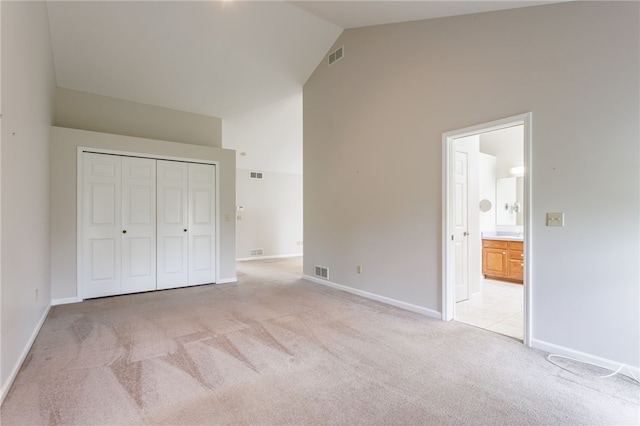 15 Stag Creek Trl, Clarkson, NY 14420 - unfurnished bedroom featuring high vaulted ceiling, light colored carpet, baseboards, connected bathroom, and a closet