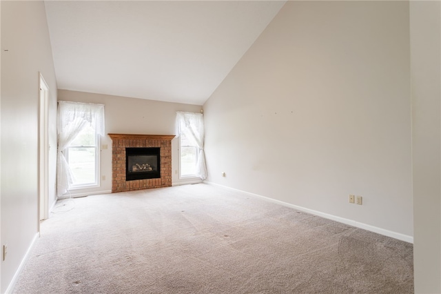 15 Stag Creek Trl, Clarkson, NY 14420 - unfurnished living room with light carpet, lofted ceiling, baseboards, and a fireplace