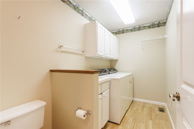 15 Stag Creek Trl, Clarkson, NY 14420 - laundry area with washer and clothes dryer, light wood-type flooring, cabinet space, and baseboards