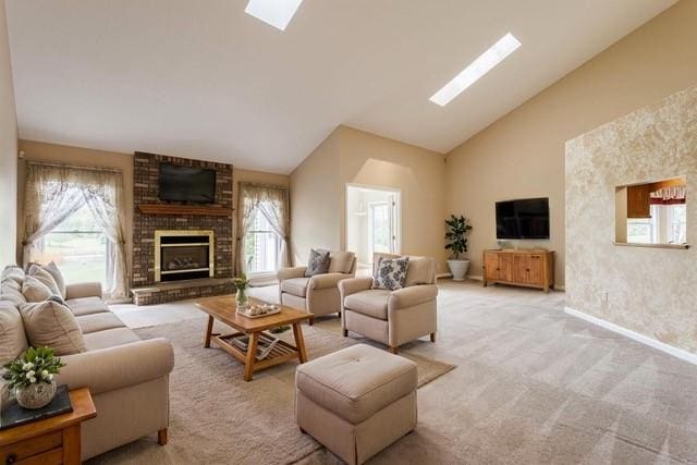 15 Stag Creek Trl, Clarkson, NY 14420 - living area with a skylight, healthy amount of natural light, high vaulted ceiling, a fireplace, and baseboards