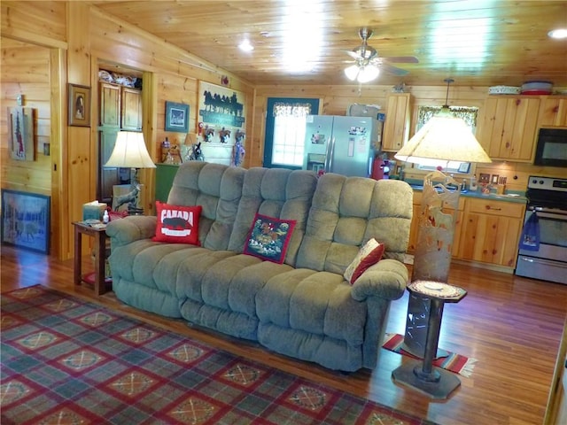 2693 Pulver Rd, Italy, NY 14418 - living room featuring wood finished floors, wooden ceiling, a ceiling fan, and wooden walls