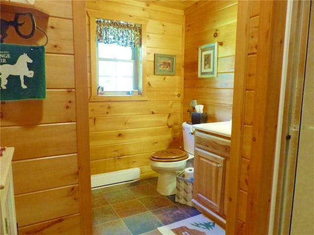 2693 Pulver Rd, Italy, NY 14418 - bathroom with a baseboard radiator, wood walls, toilet, vanity, and stone finish flooring