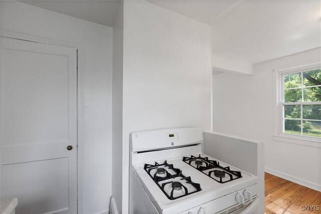 508 W Brighton Ave, Syracuse, NY 13205 - kitchen with white range with gas cooktop, light wood-style flooring, baseboards, and light countertops