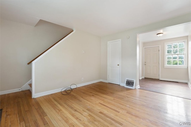508 W Brighton Ave, Syracuse, NY 13205 - unfurnished living room with light wood-type flooring, stairs, and baseboards