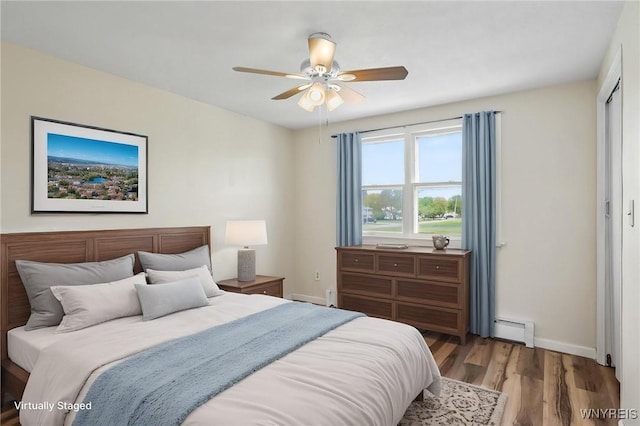 307 Wadsworth Ct, Tonawanda-City, NY 14150 - bedroom with baseboard heating, light wood-style flooring, baseboards, and ceiling fan