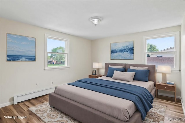 307 Wadsworth Ct, Tonawanda-City, NY 14150 - bedroom featuring baseboard heating, light wood-style flooring, and baseboards