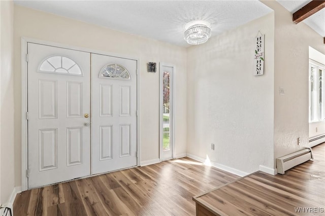 307 Wadsworth Ct, Tonawanda-City, NY 14150 - foyer featuring baseboard heating, wood finished floors, a chandelier, and baseboards