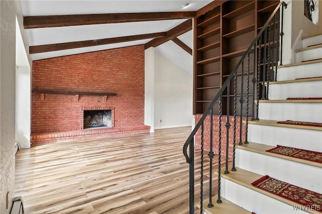307 Wadsworth Ct, Tonawanda-City, NY 14150 - staircase with wood finished floors, a fireplace, and a baseboard radiator
