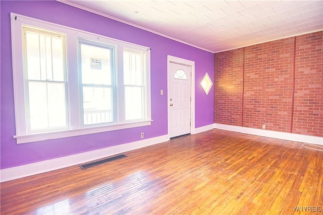 587 Goodyear Ave, Buffalo, NY 14211 - foyer entrance featuring wood-type flooring, baseboards, crown molding, and brick wall