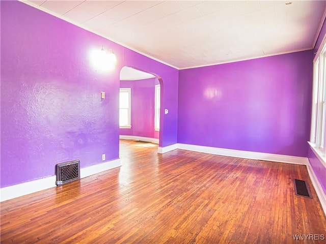 587 Goodyear Ave, Buffalo, NY 14211 - empty room with arched walkways, hardwood / wood-style floors, ornamental molding, and baseboards
