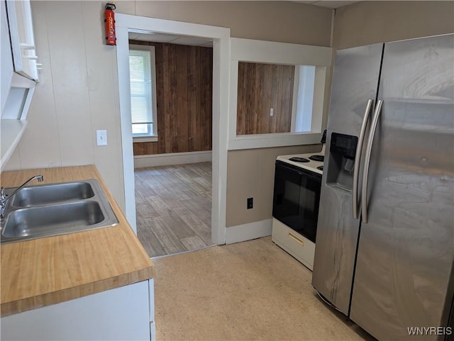 334 N 13th St, Olean-City, NY 14760 - kitchen featuring stainless steel refrigerator with ice dispenser, electric range oven, a sink, baseboards, and light wood finished floors