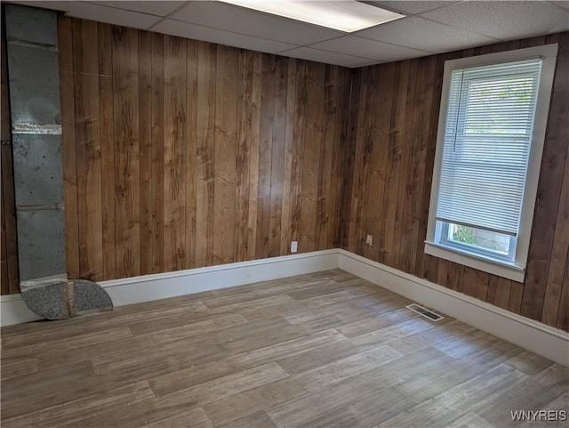 334 N 13th St, Olean-City, NY 14760 - unfurnished room featuring wood finished floors, wood walls, and a drop ceiling