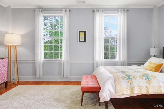 2875 W Lake Rd, Cazenovia, NY 13035 - bedroom featuring wood finished floors, multiple windows, ornamental molding, and baseboards