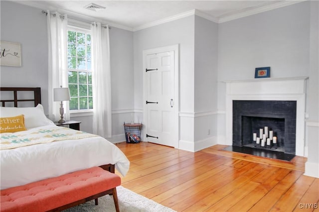 2875 W Lake Rd, Cazenovia, NY 13035 - bedroom with hardwood / wood-style floors, a fireplace, and ornamental molding